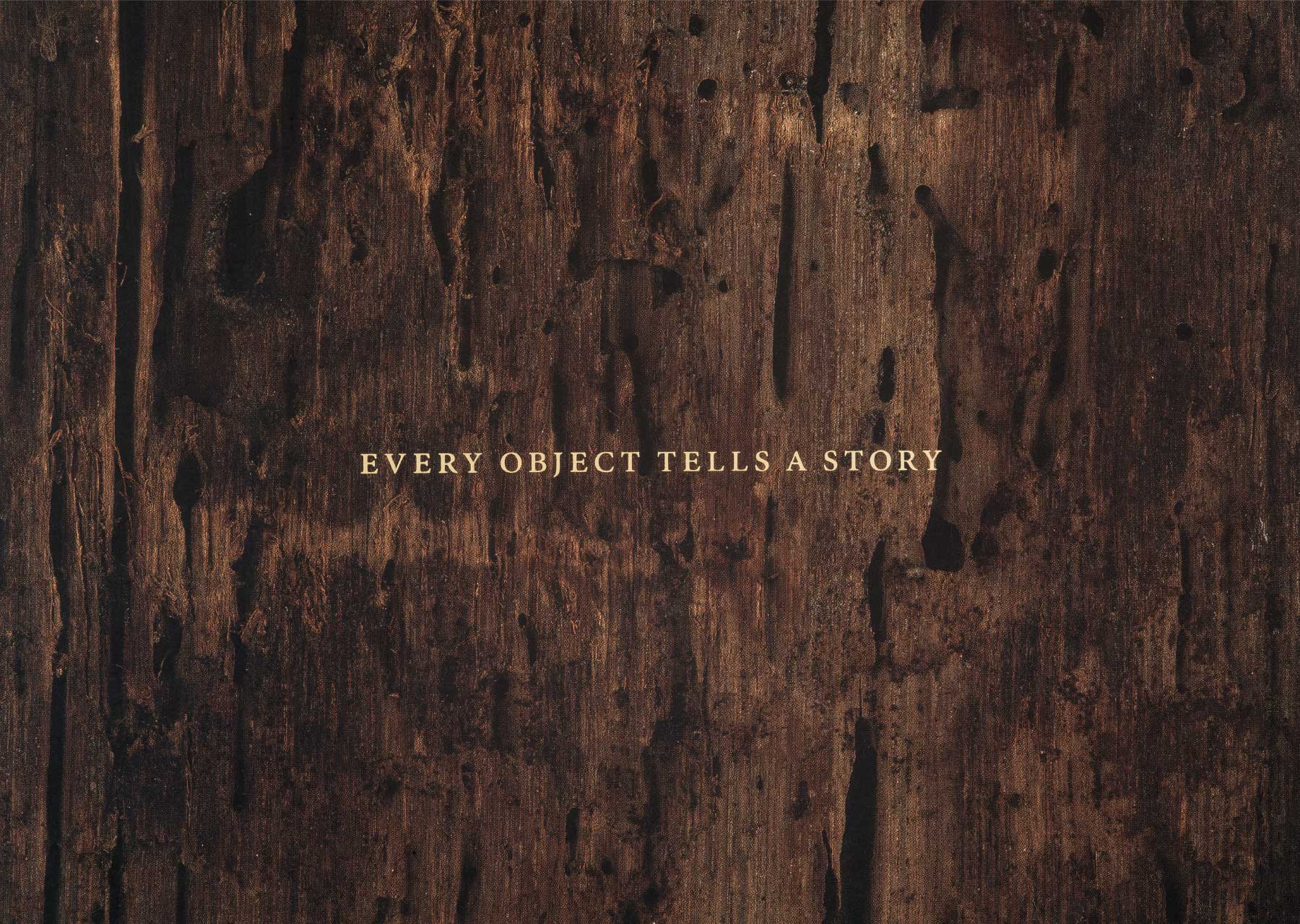 Every object tells a story in a serif typeface on top of an image of weathered wood
