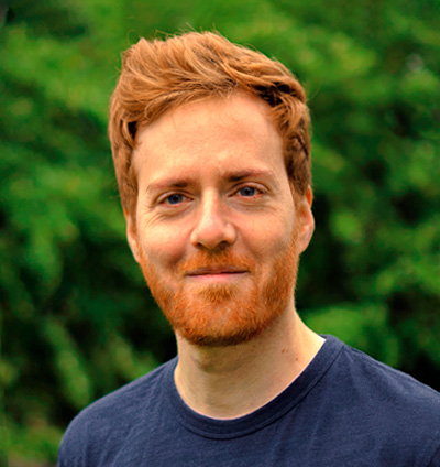Profile picture of Benjamin Strachan smiling in front of a background of trees