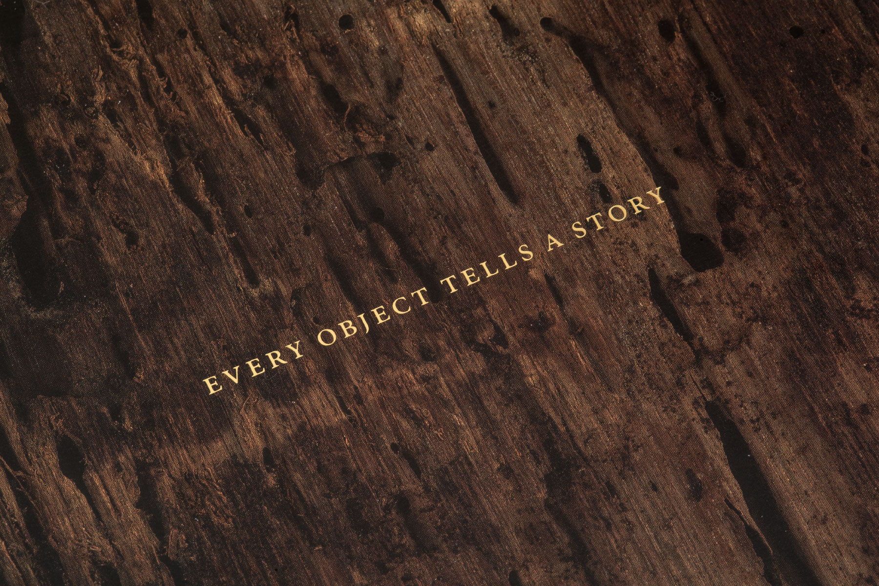 Serif type in small capitals with generous letter-spacing in gold-foil